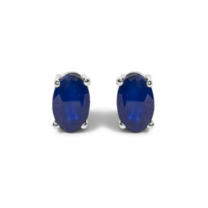 Pair of oval blue sapphire stud earrings in rhodium-plated sterling silver with four-prong settings